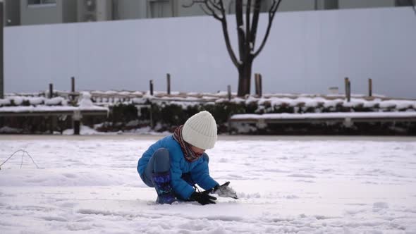 Cute Asian Child Playing Snow In The Park