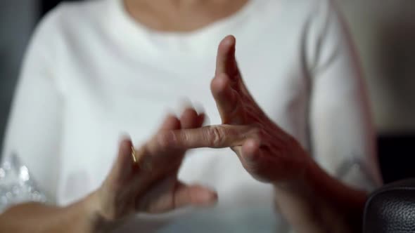 Woman Is Clapping on Fingers of Her Hand, Massaging Joints, Ayurvedic Procedure