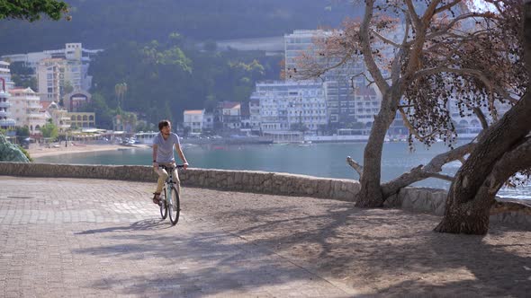 A Young Man Rides a Bicycle in the City of Budva a Famous Tourist Place in Montenegro