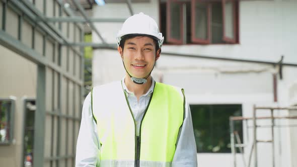 Asian workers people removes protective face mask onsite of architecture due to Covid19 pandemic.