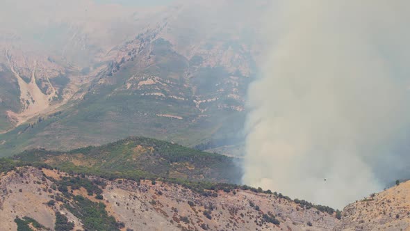 Smoke filling the air from wildfire burning on mountain side