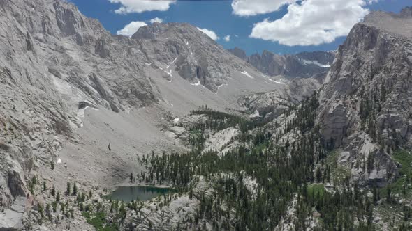 Bird Eye View on Scenic Peaks and Summit with Snow Blue Sky Clouds