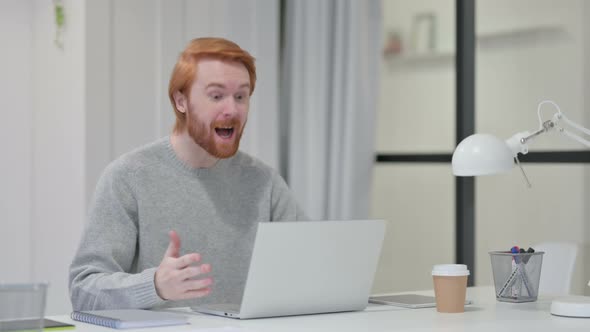 Redhead Man Talking on Video Chat on Laptop 