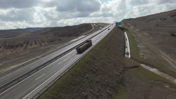 Motorway with driving cars and large cargo truck