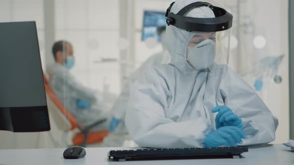 Dentistry Specialist Holding x Ray While Using Computer