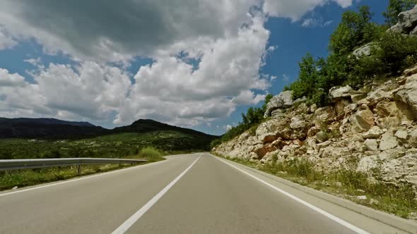 Camera Moving Fast Over Asphalt Road on Cloudy Day in Green Nature of Montenegro.