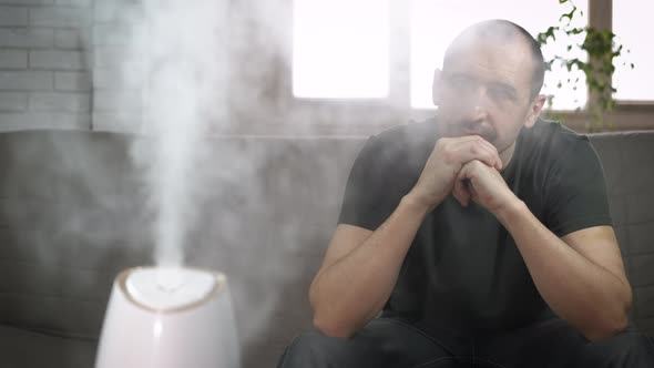 Pensive Man in Steam in Room