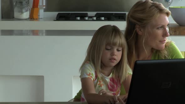 MS Tracking Left OF A MOTHER AND DAUGHTER USING A LAPTOP