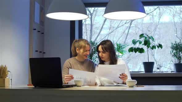 Female Coworkers Working in Late Evening