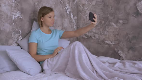 Young Woman Taking a Photo at Home