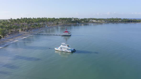 Catamaran Boat And Gazebo In The Coast Of Bahia Principe Grand La Romana Hotel At Summer. - aerial