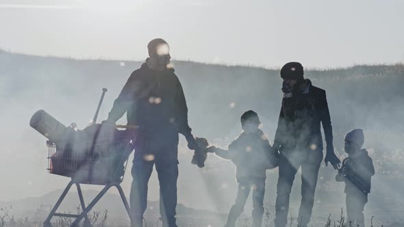 Portrait of survivor family in gas mask standing in clouds of toxic smoke