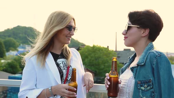Young Women Drinking Beer Outdoors, Having Fun Outdoors
