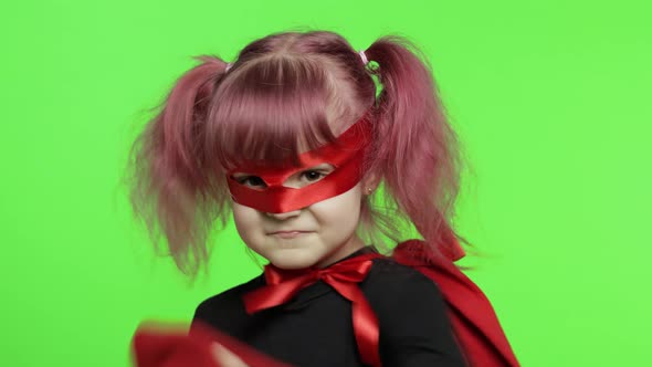 Funny Child Girl in Costume and Mask Plays Super Hero. National Superhero Day