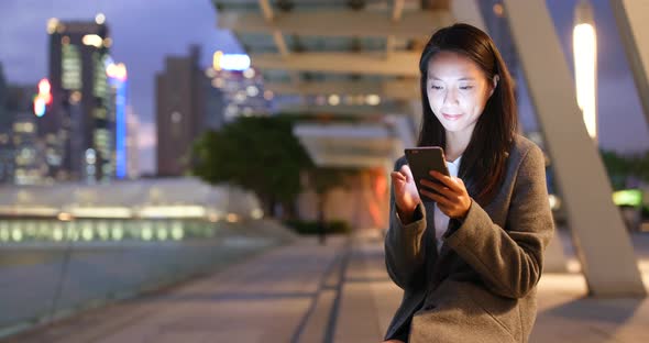 Businesswoman use of cellphone at night