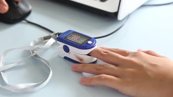 Close-up video of a woman's finger measuring blood oxygen levels before receiving the corona virus v