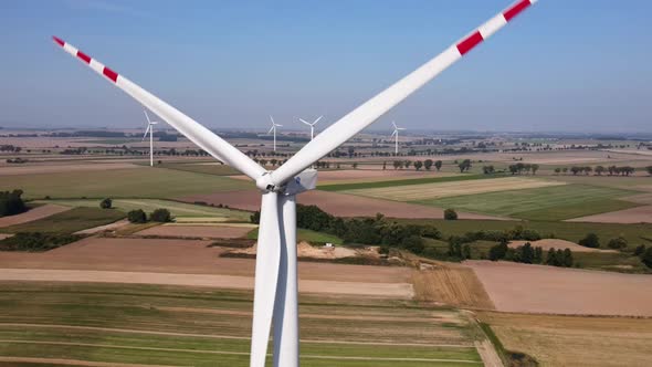 Windmill Turbine in the Field at Summer Day