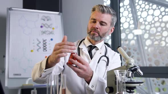 Male Doctor which Wearing White Gown and Stethoscope Exploring 