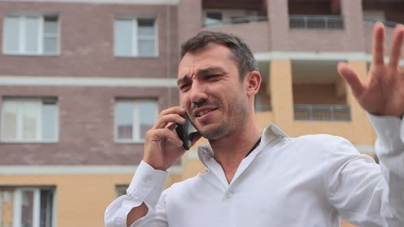 Closeup of a Businessman with Delight and Joy Speaks on the Phone