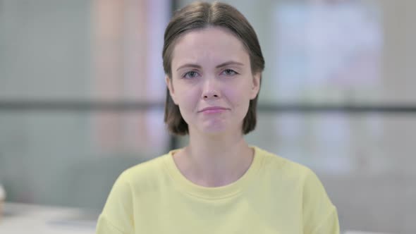 Portrait of Young Woman Looking at the Camera Sad Expression