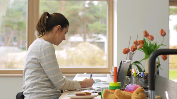 Young Woman with Laptop Working at Home Office