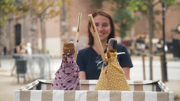 Woman Standing on the Street Festival Smiling and Have Fun Watching Toys Puppets Show on Street