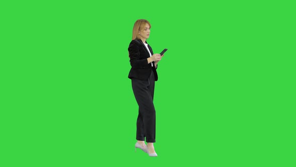 Beautiful and Happy, Smiling Young Business Woman Interact with Phone Application on a Green Screen