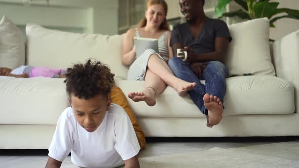 Woman Man Using Tablet and Sitting on Couch While Boy Playing with Smartphone at Home Room Spbd