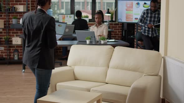 Female Manager Looking at Sales Report on Laptop Computer