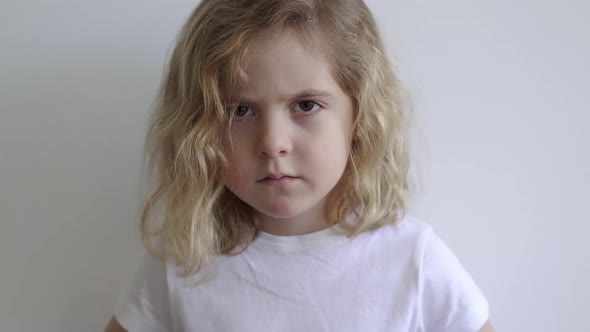 Frowned girl standing in studio