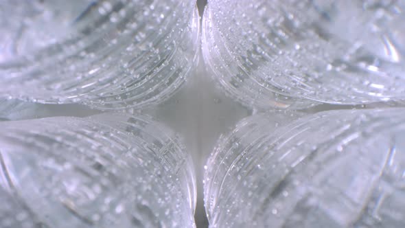 Wet Cold Plastic Bottles of Mineral Water