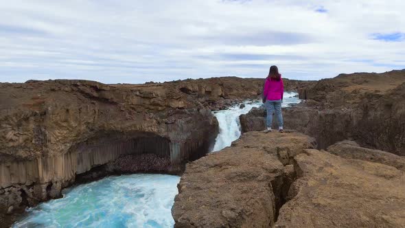 Traveler Hiking at Aldeyjarfoss Waterfall in Iceland