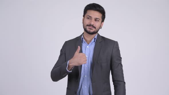 Young Happy Bearded Indian Businessman Giving Thumbs Up