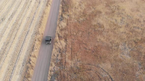 Ranger Driving Down Dirt Road in Utah Mountains in the Fall During Dusk Top Aerial Drone View 4K