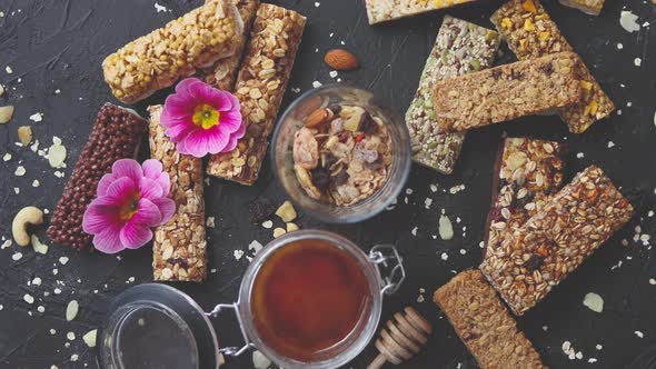 Healthy Superfood Composition. Various Kinds Granola Energy Protein Bars with Honey in Jar