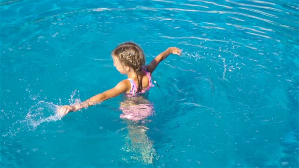 Adorable Little Girl in Outdoor Swimming Pool