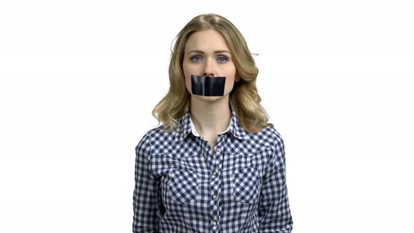 Young Woman with Black Tape Over Mouth