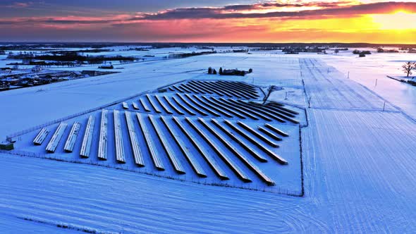 Snowy solar panels. Frozen solar panels in winter. Alternative energy.