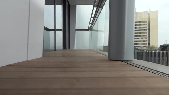 Camera Captures a New, Modern Balcony and It's Wooden Floor, Goes From One Side To Another.