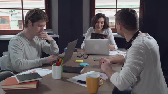 Employees Using Tablet and Computer Indoor