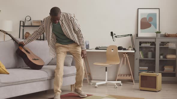 Male African-American Guitarist Working in Home Studio