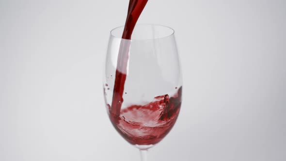 Pouring red wine into glass, Slow Motion