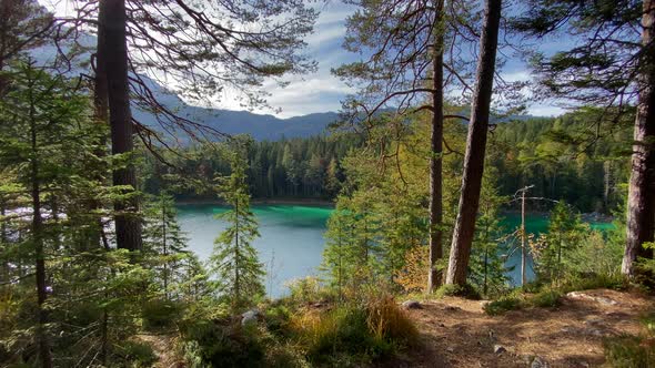 Panoramic view of a forest with the beautiful Eibsee lake in Bavaria behind, with turquoise water, v