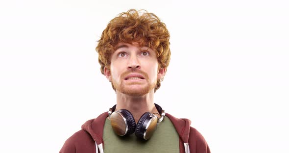 Beautiful Happy Fun Young Adult Redhead Man Listening to Music By Headphones Doing Happyserious