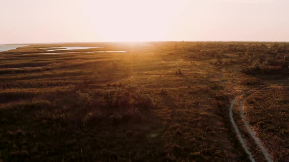 Aerial Landscape View of Beautiful Lake Among Grass Flowing Into Black Sea in the Evening Against