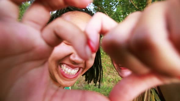 Two young women sending love to the camera