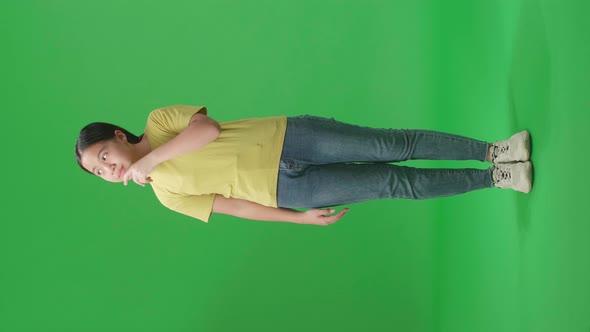 Full Body Of Young Asian Kid Girl Thinking Then Raising Her Index Finger On Green Screen The Studio