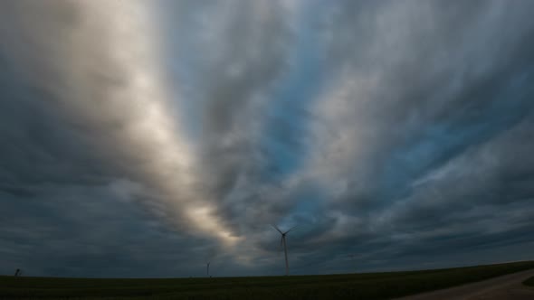 Wind mill turbines timelapse with cloudy sky. 