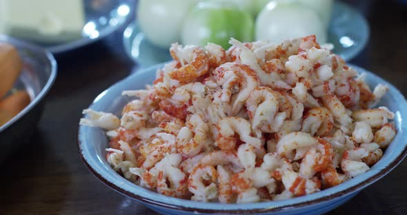 fresh shrimps peeled and ready to eaten served on blue plate on wooden table, healthy seafood for ke