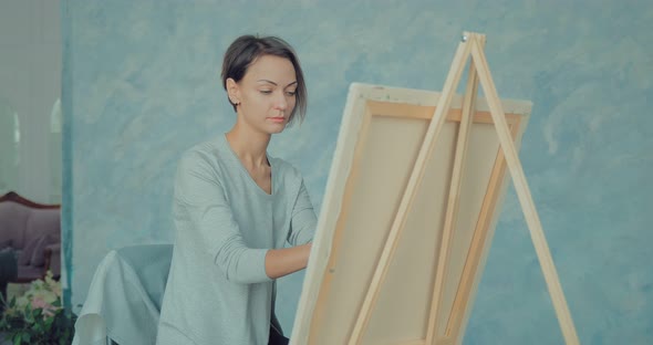 Young Woman Inspired Draws at the Easel